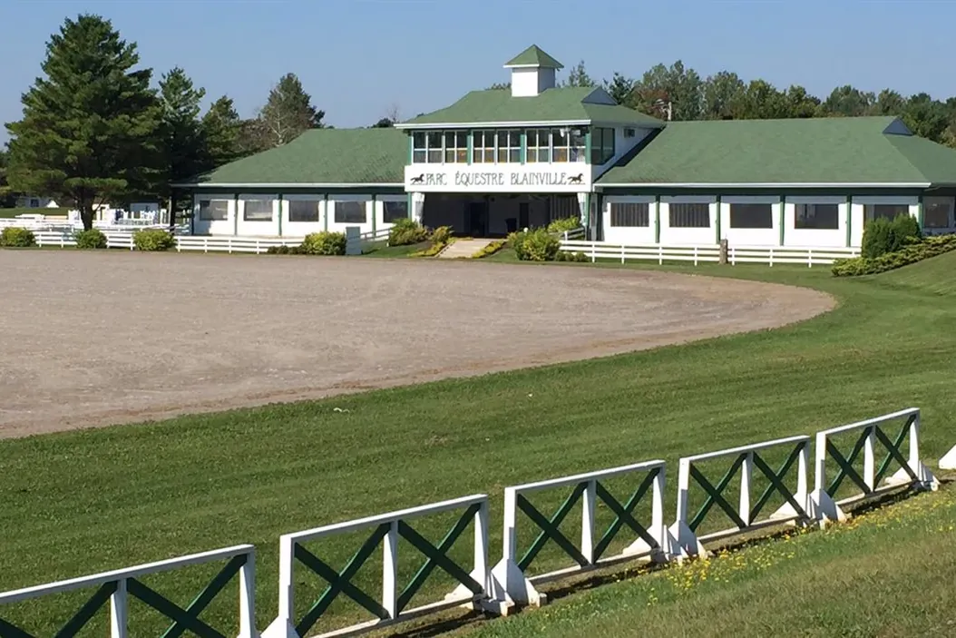 The main building and riding ring at the Parc équestre de Blainville