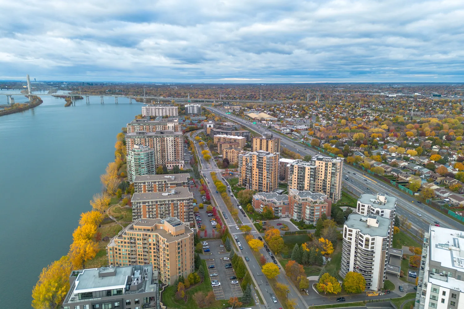 Condo towers along the St. Lawrence in Brossard, with the Samuel-De Champlain Bridge in the distance