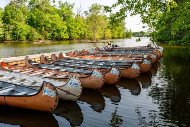Canoes lined up along the Rivière des Mille Îles in Sainte-Rose, Laval