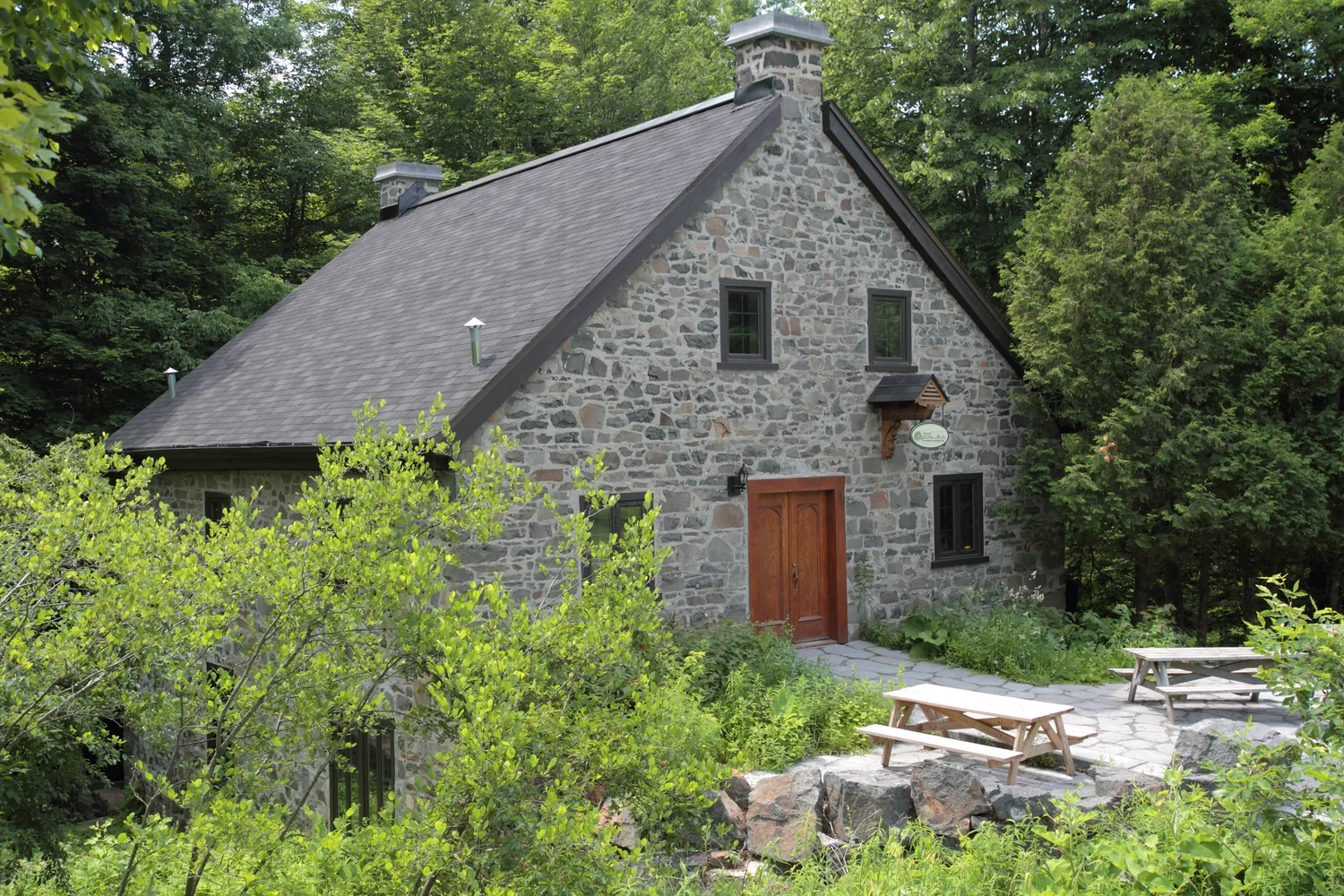 The old stone mill among the trees in Parc national du Mont-Saint-Bruno