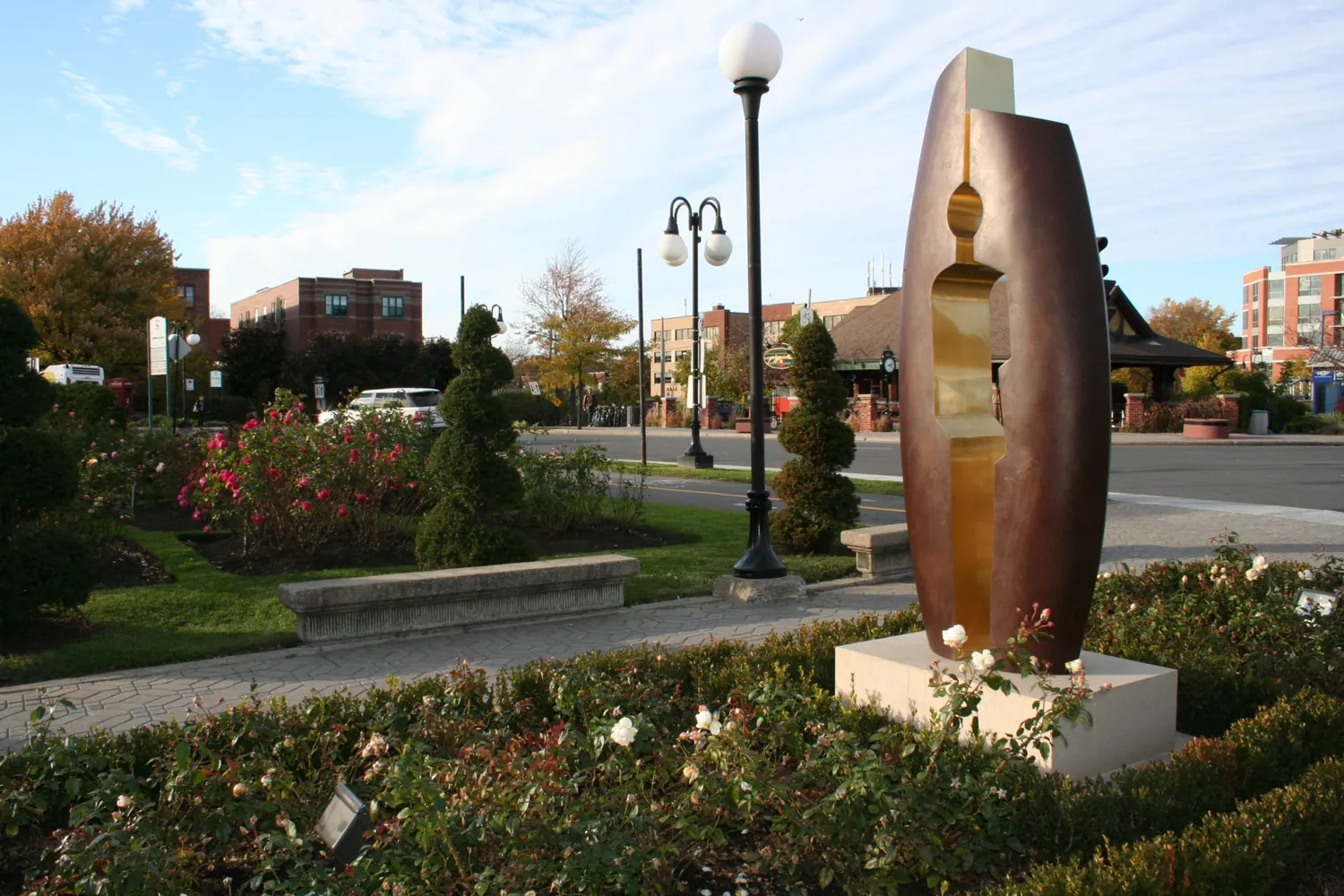 Rose beds and a bronze sculpture in the Pierre Elliott Trudeau Rose Garden at Connaught Park, Town of Mount Royal